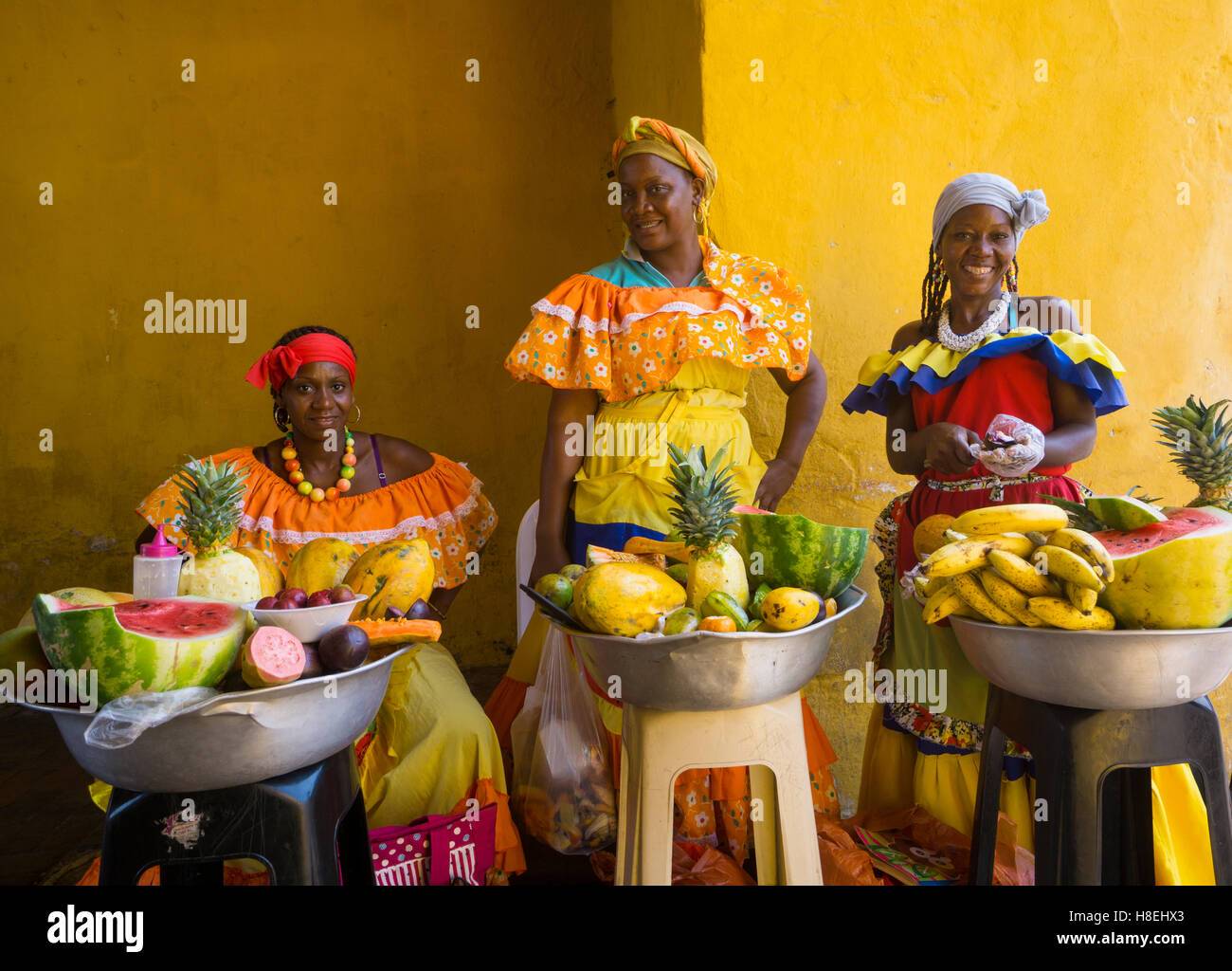 Women in traditional costume selling fruit in Cartagena, Colombia, South America Stock Photo