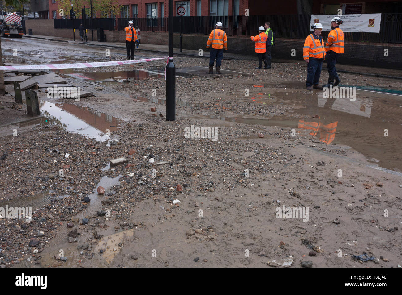 Waters subside leaving a mess of silt and stones after a main water main burst on Camberwell New Road, Southwark, London. Stock Photo