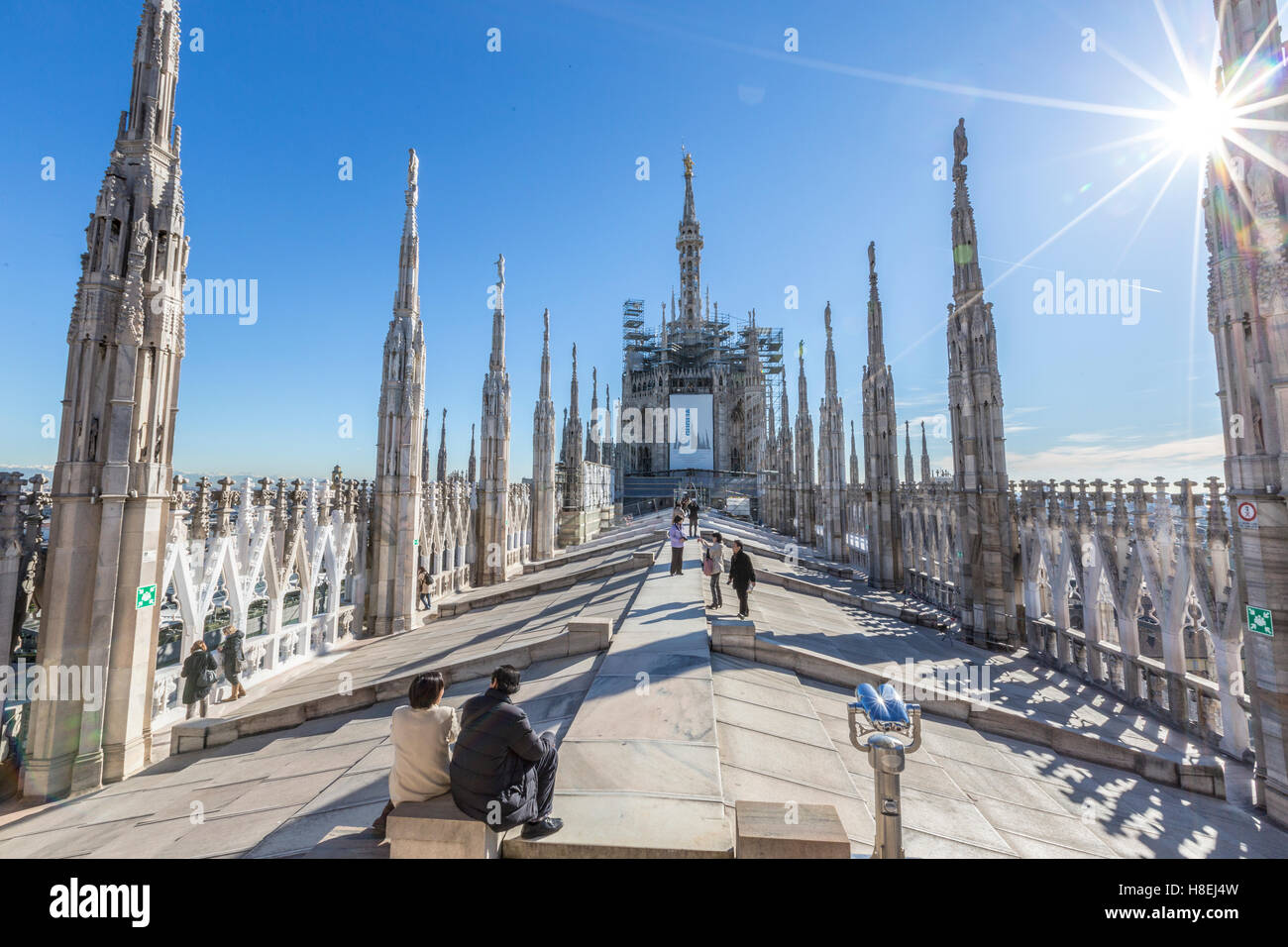 Tourists among the white marble spiers on the top of the Duomo, Milan, Lombardy, Italy, Europe Stock Photo
