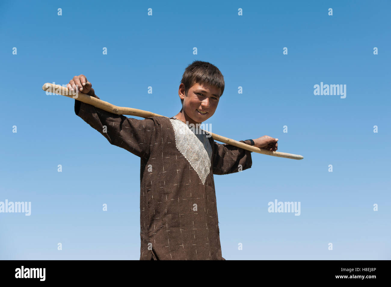 Shepherd boy takes a break in the hot sun in Bamiyan Province, Afghanistan, Asia Stock Photo