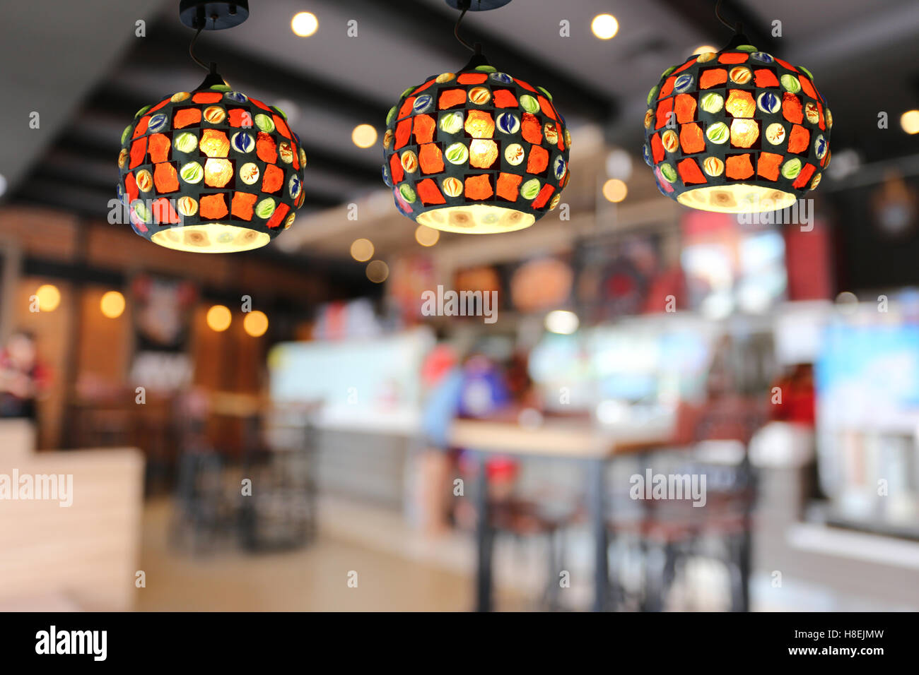 Warm lighting modern ceiling lamps in the cafe and interior decoration restaurant. Stock Photo