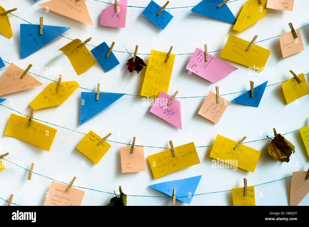 Postit notes in children's handwriting pegged on string along with