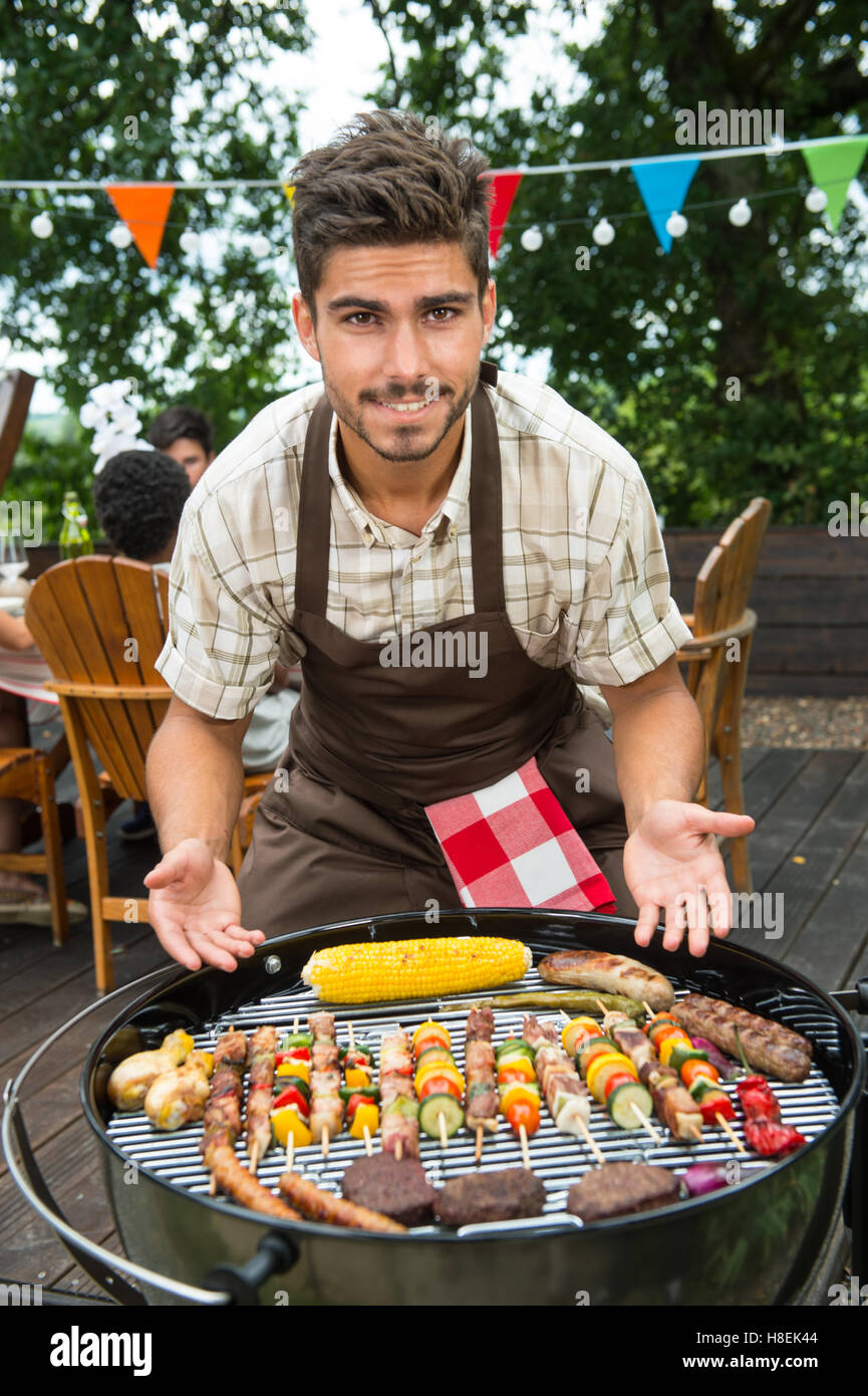 Teenagers during barbecue family garden hires stock photography and