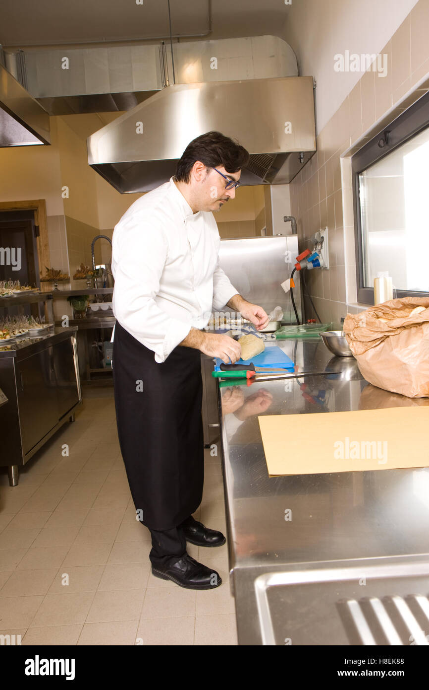 cook working in a kitchen restaurant Stock Photo - Alamy