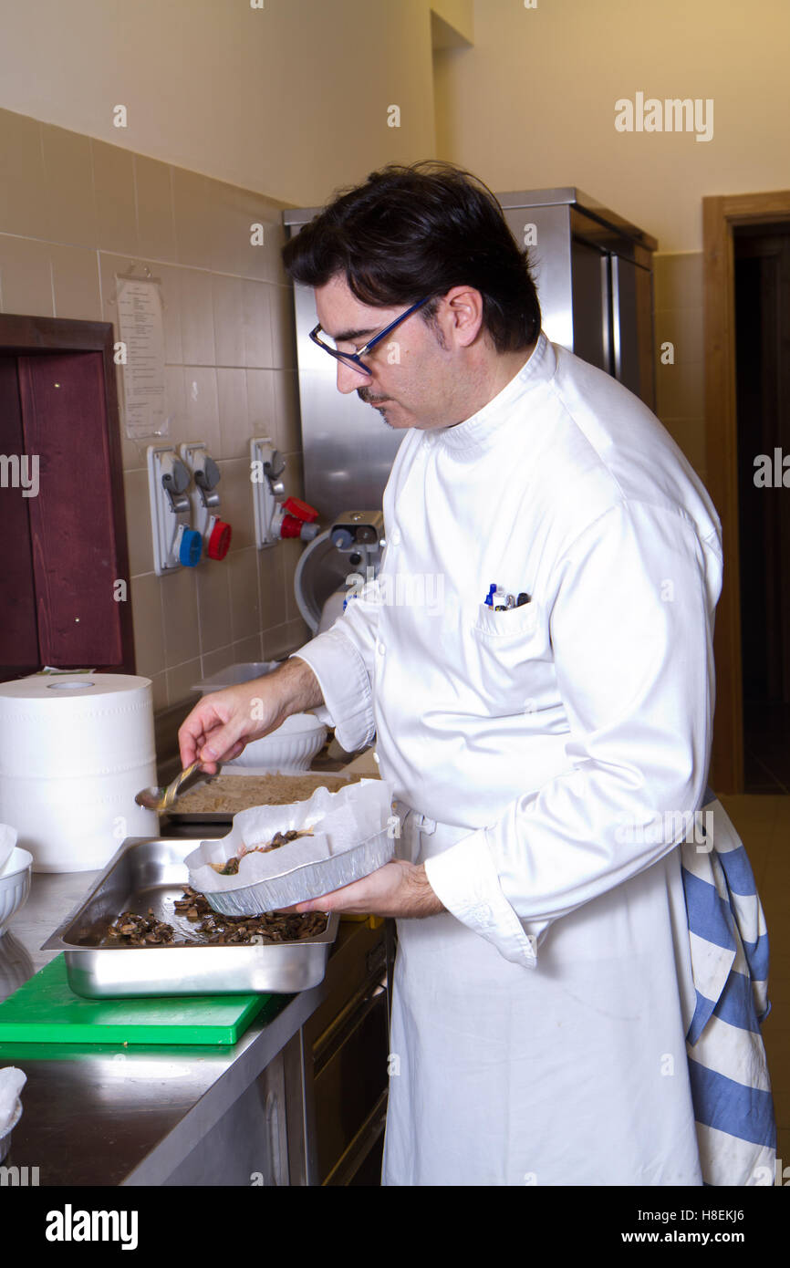 cook working in a kitchen restaurant Stock Photo - Alamy