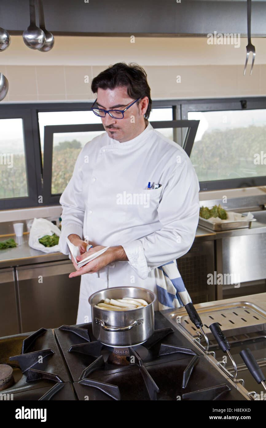 cook working in a kitchen restaurant Stock Photo - Alamy