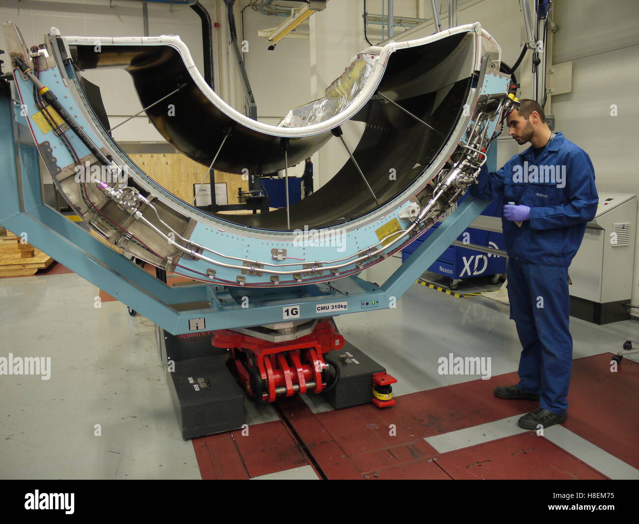 Worker in Safran plant of Le Havre (France) work on a nacelle system for aeronautical Stock Photo
