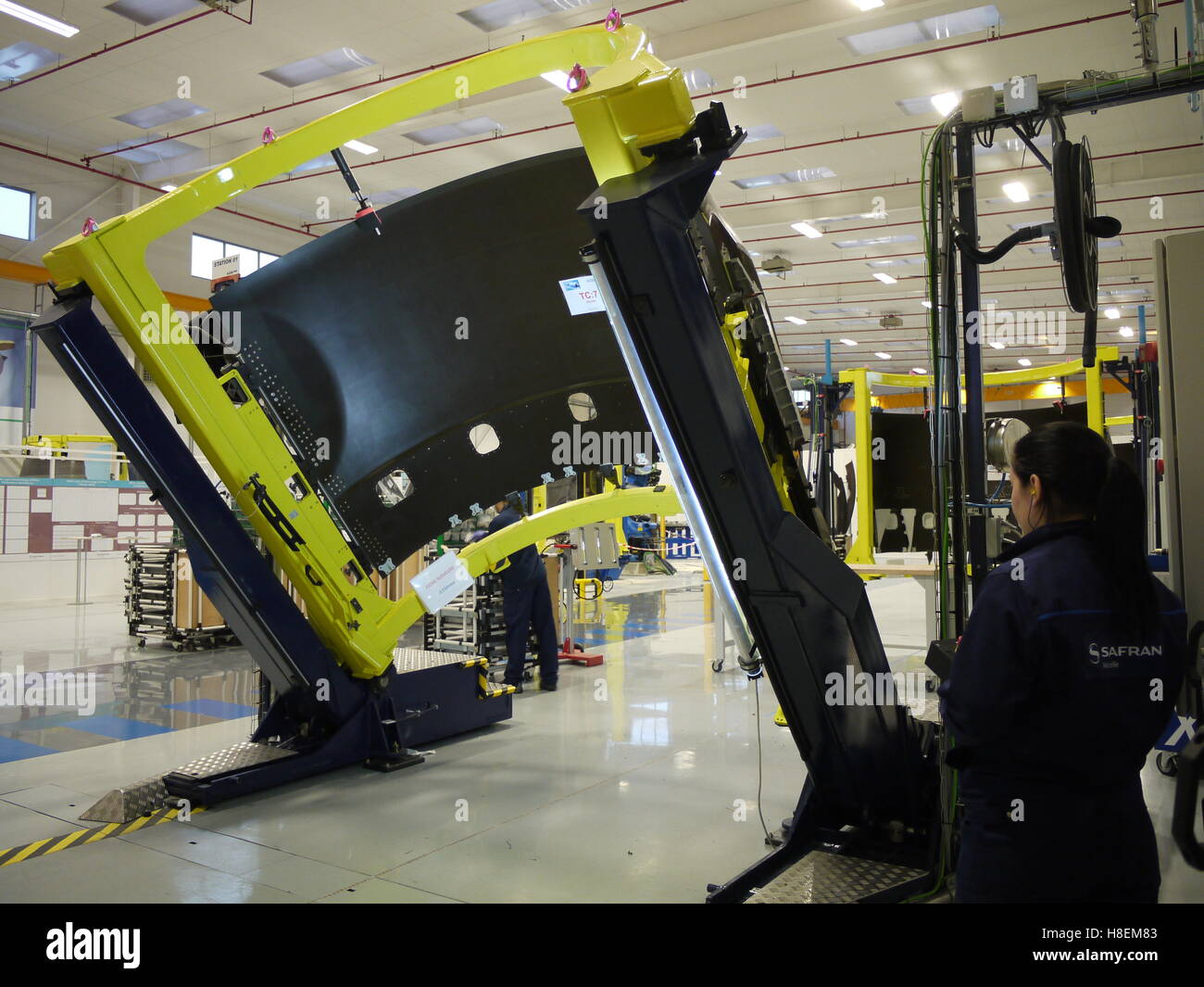 Worker in Safran plant of Le Havre (France) move a nacelle system in carbon for aeronautical using ergonomics system Stock Photo