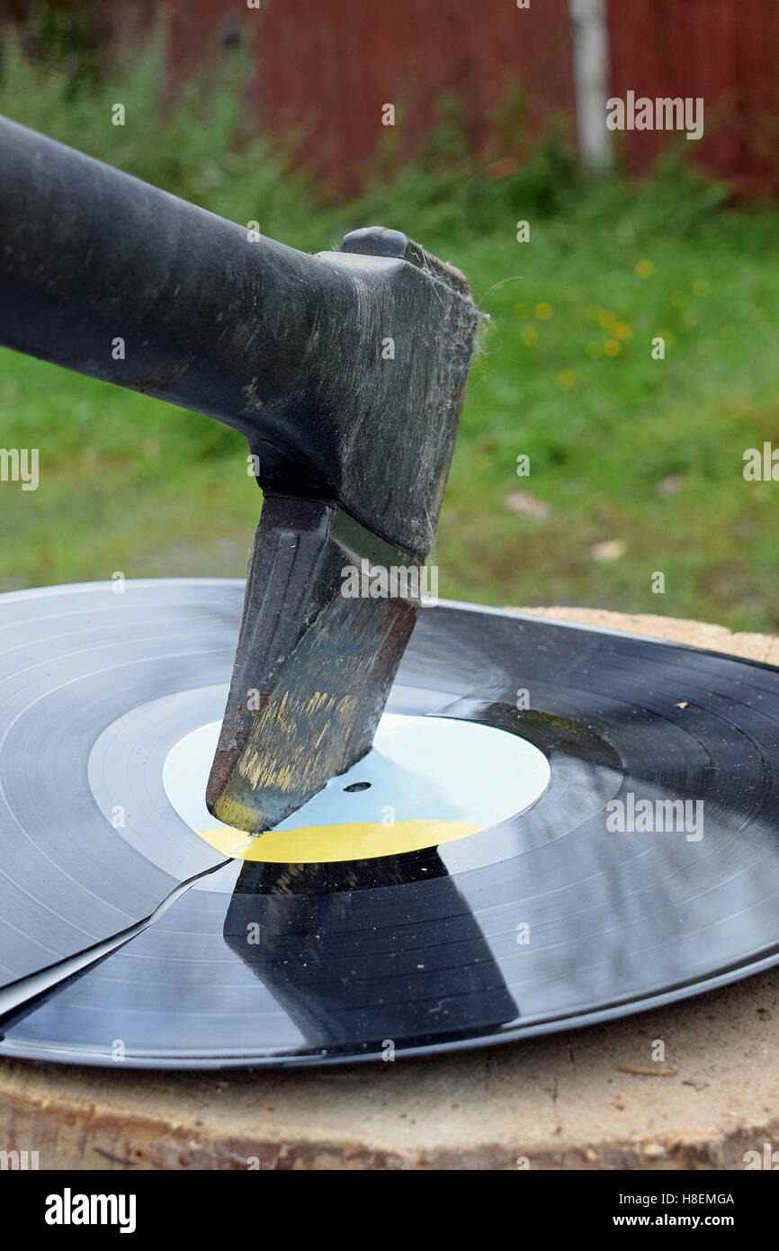 Axe destroying a vinyl record Stock Photo