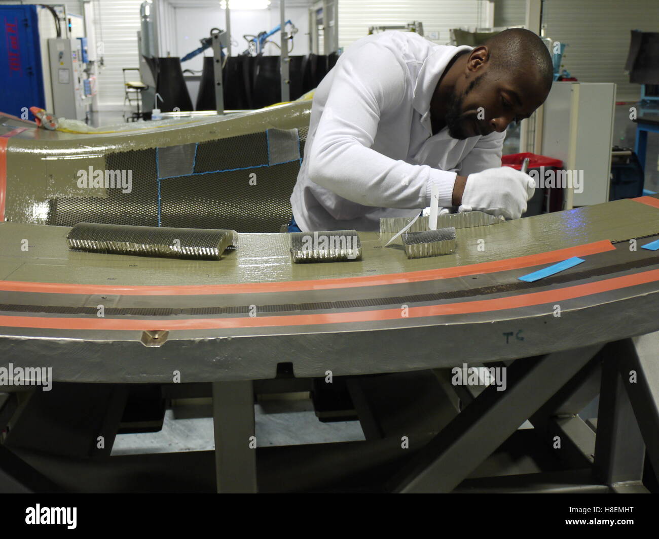 Worker in Safran plant of Le Havre (France) work on a nacelle system in carbon for aeronautic Stock Photo