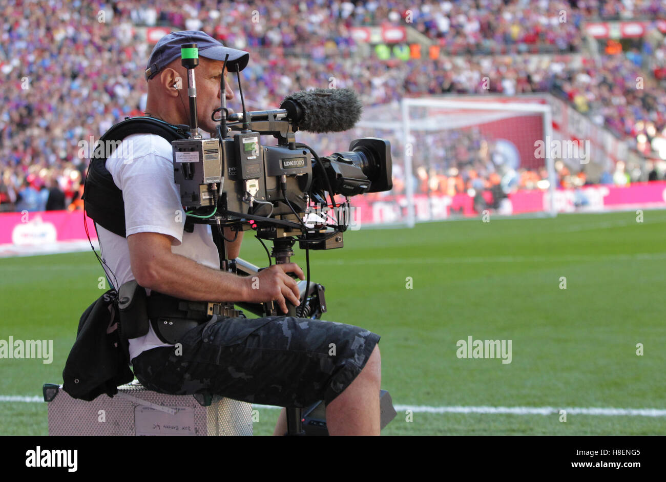 Television Cameraman with a Steadicam system at a football match Stock