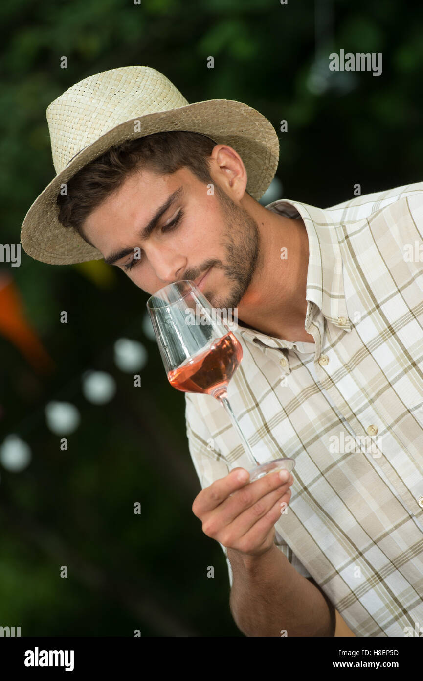 Handsome mature man tasting glass of rose wine outdoor Stock Photo - Alamy