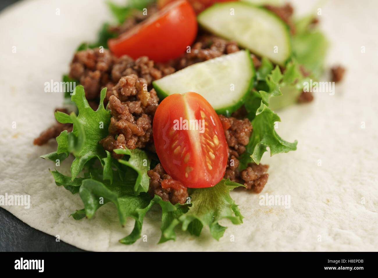 open tortilla with beef, frillice and vegetables Stock Photo