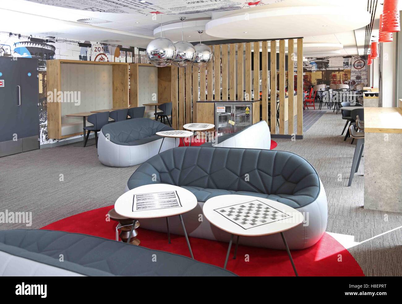 Bar lounge and breakfast area in a new Ibis Hotel in Cambridge, UK. Shows modern sofas with restaurant area beyond Stock Photo
