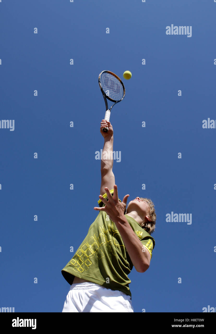 Boy playing tennis, junior player, service Stock Photo