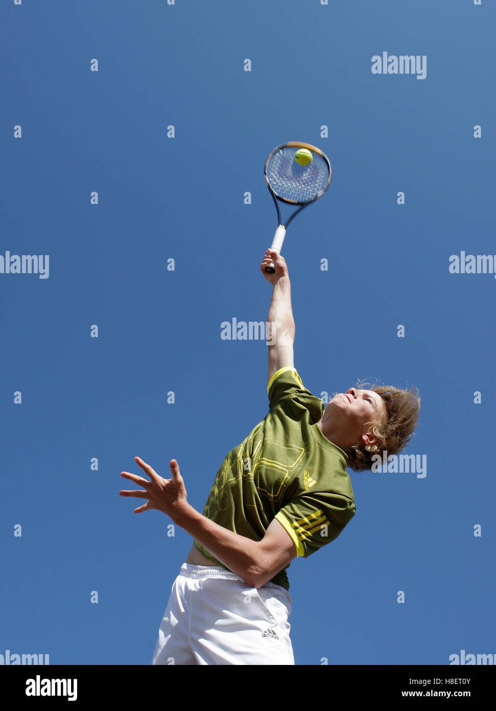 Boy playing tennis, junior player, service Stock Photo