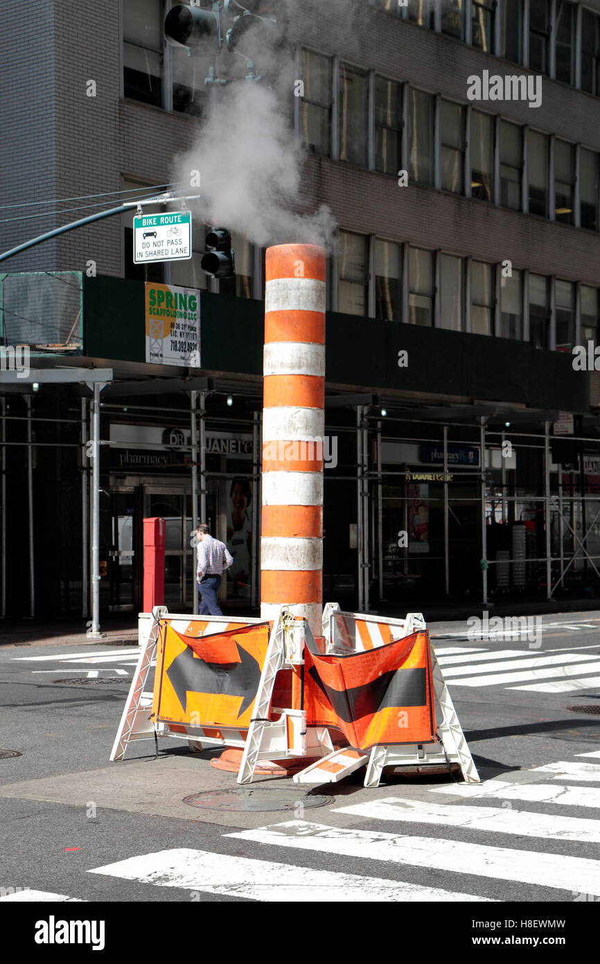 Steam vapor being released through a typical Con Edison orange and white stack in Manhattan, New York City, United States. Stock Photo