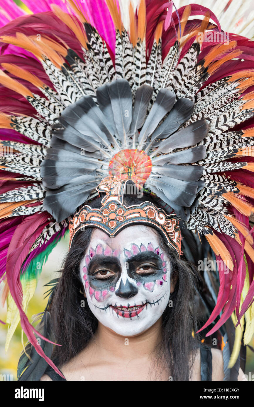 A young woman dressed as an Aztec skeleton during the Day of the Dead festival in the Plaza Civica October 27, 2016 in San Miguel de Allende, Guanajuato, Mexico. The week-long celebration is a time when Mexicans welcome the dead back to earth for a visit and celebrate life. Stock Photo