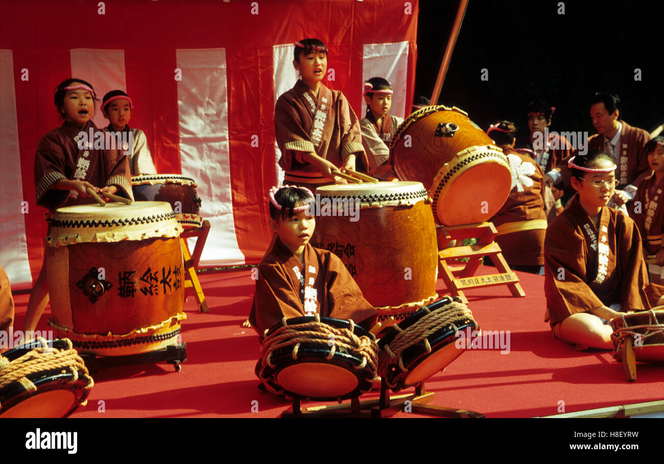 Japanese children playing traditional drums for the Shichi-Go-San festival ( rite of passage ) at the Meiji shrine in Tokyo. Stock Photo
