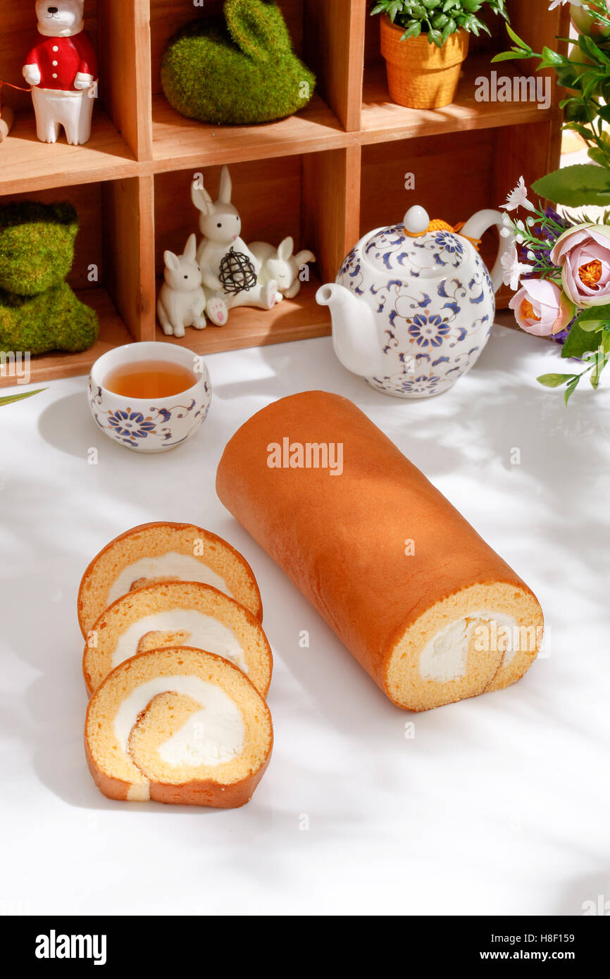 Swiss Sponge Roll With Cream on White table Stock Photo
