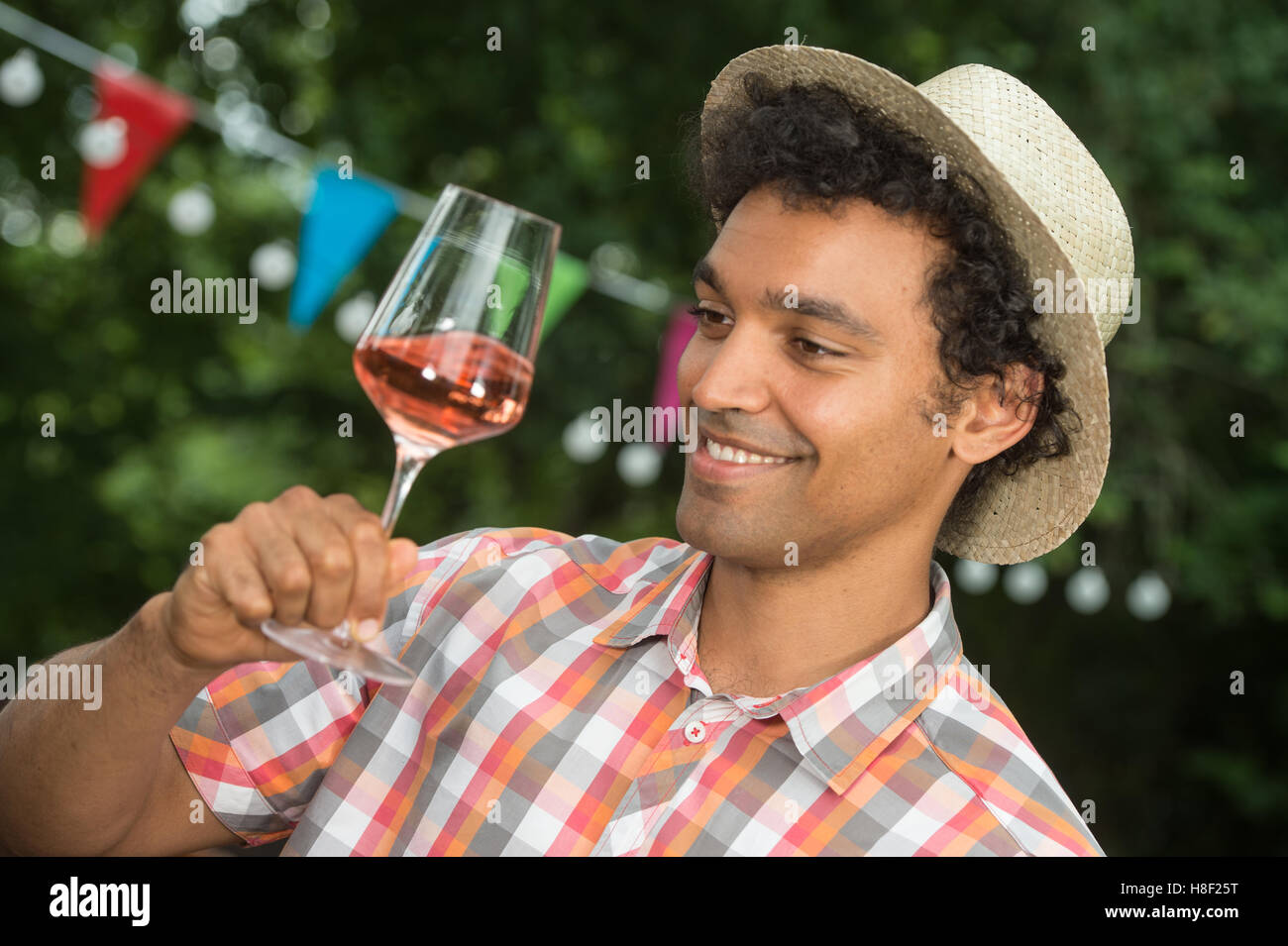 Handsome mature man tasting glass of rose wine outdoor Stock Photo - Alamy