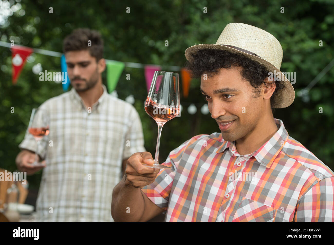 Handsome mature man tasting glass of rose wine outdoor Stock Photo - Alamy