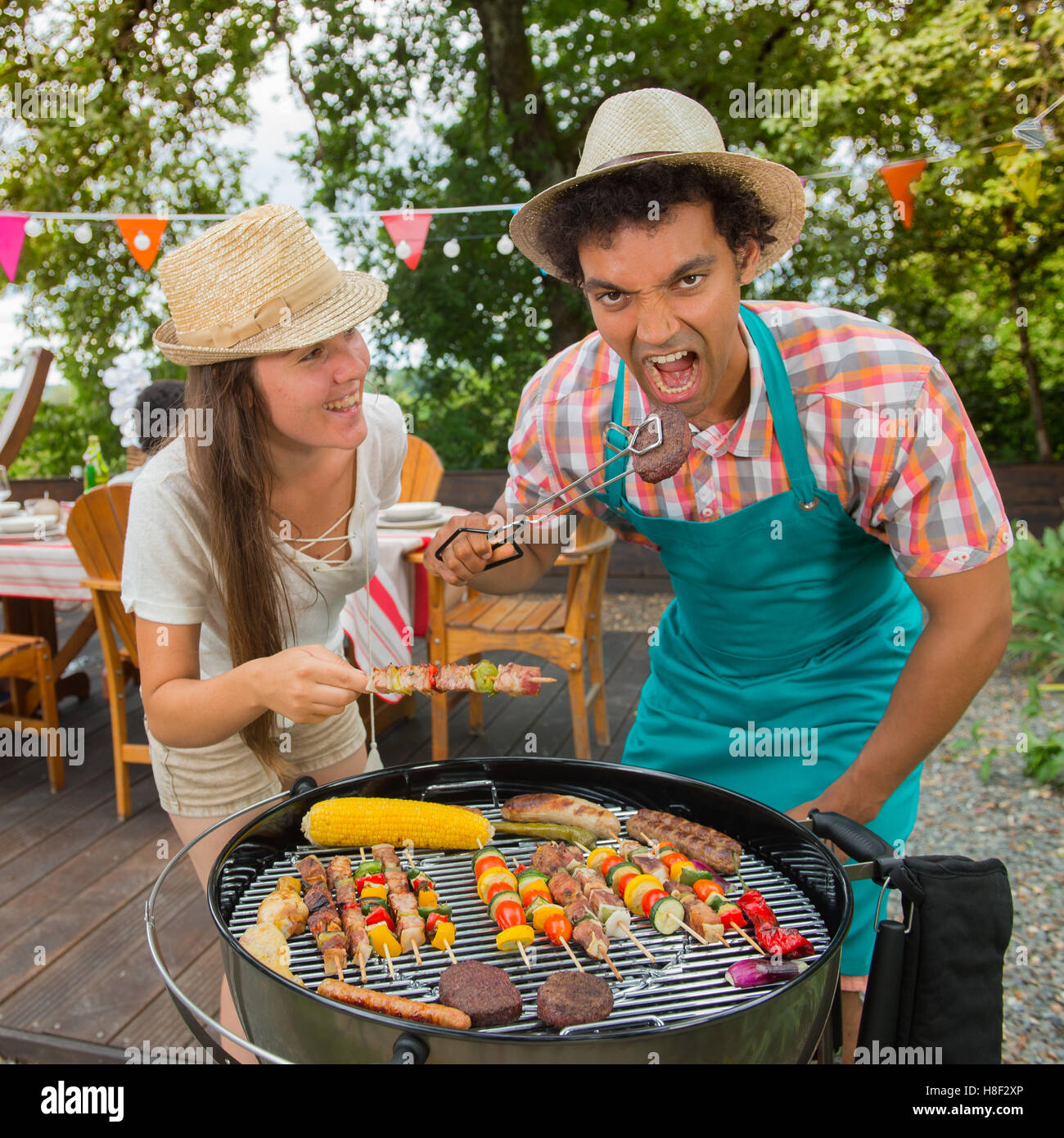 Teenagers during a barbecue at family garden BBQ, outdoor Stock Photo