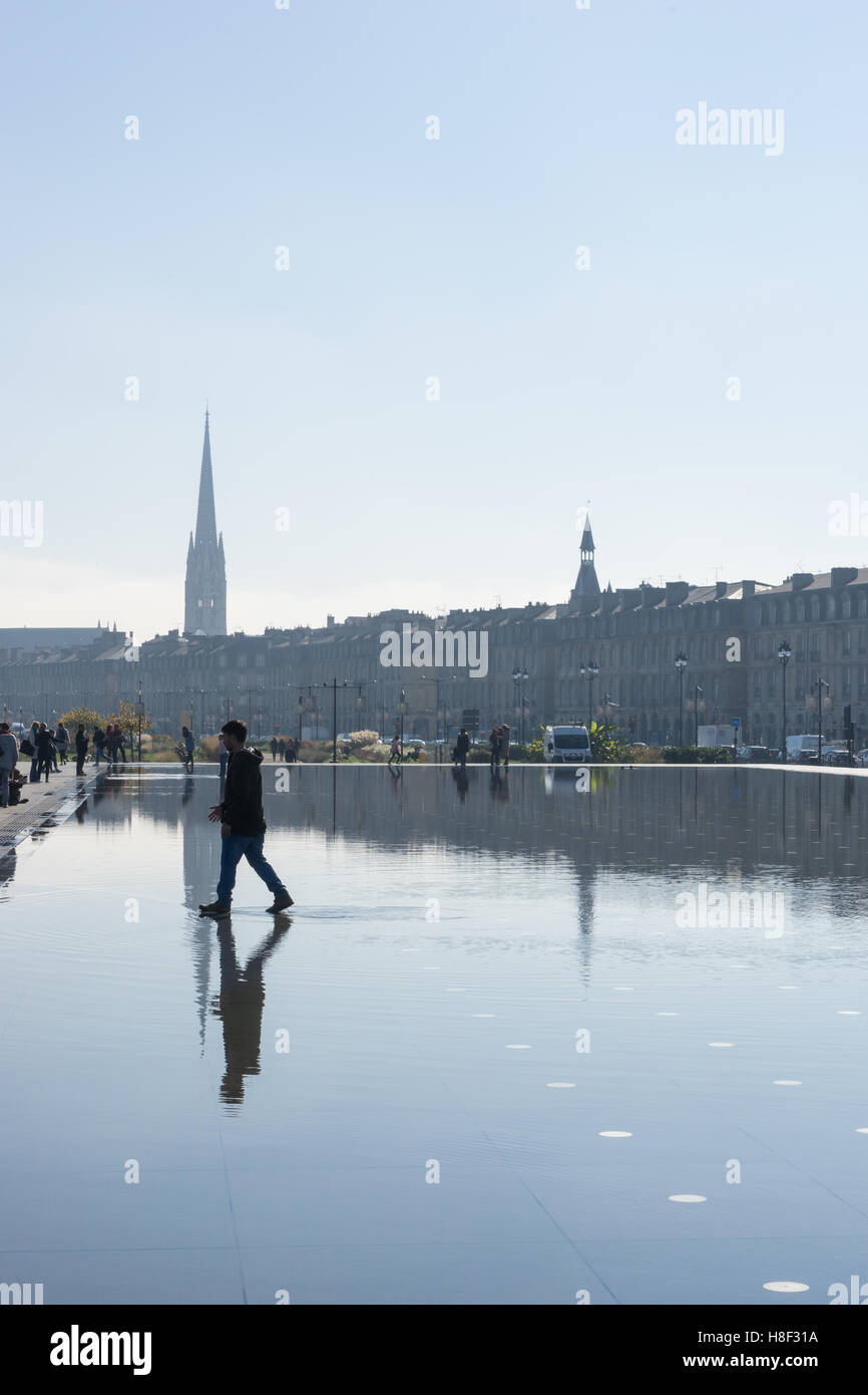 Man walking on the water mirror in Bordeaux, France Stock Photo