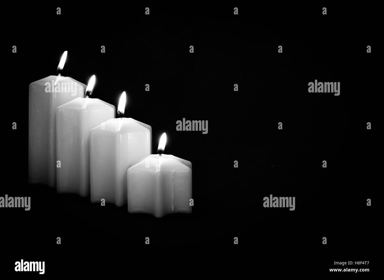 burning red advent candles with black background Stock Photo Alamy