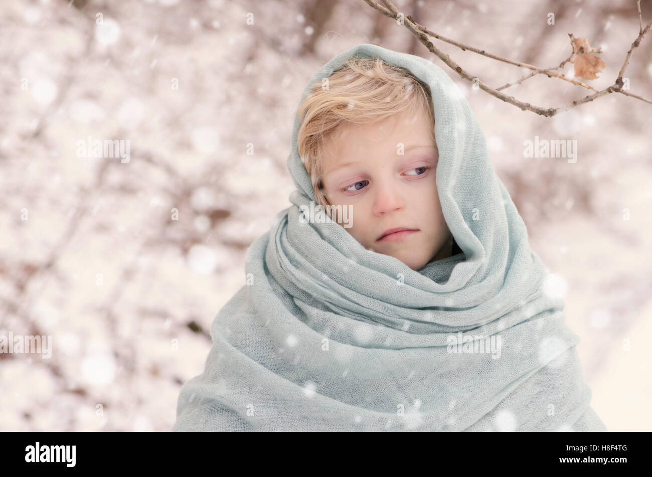 lovely blond child with blue scarf outdoor in winter time Stock Photo