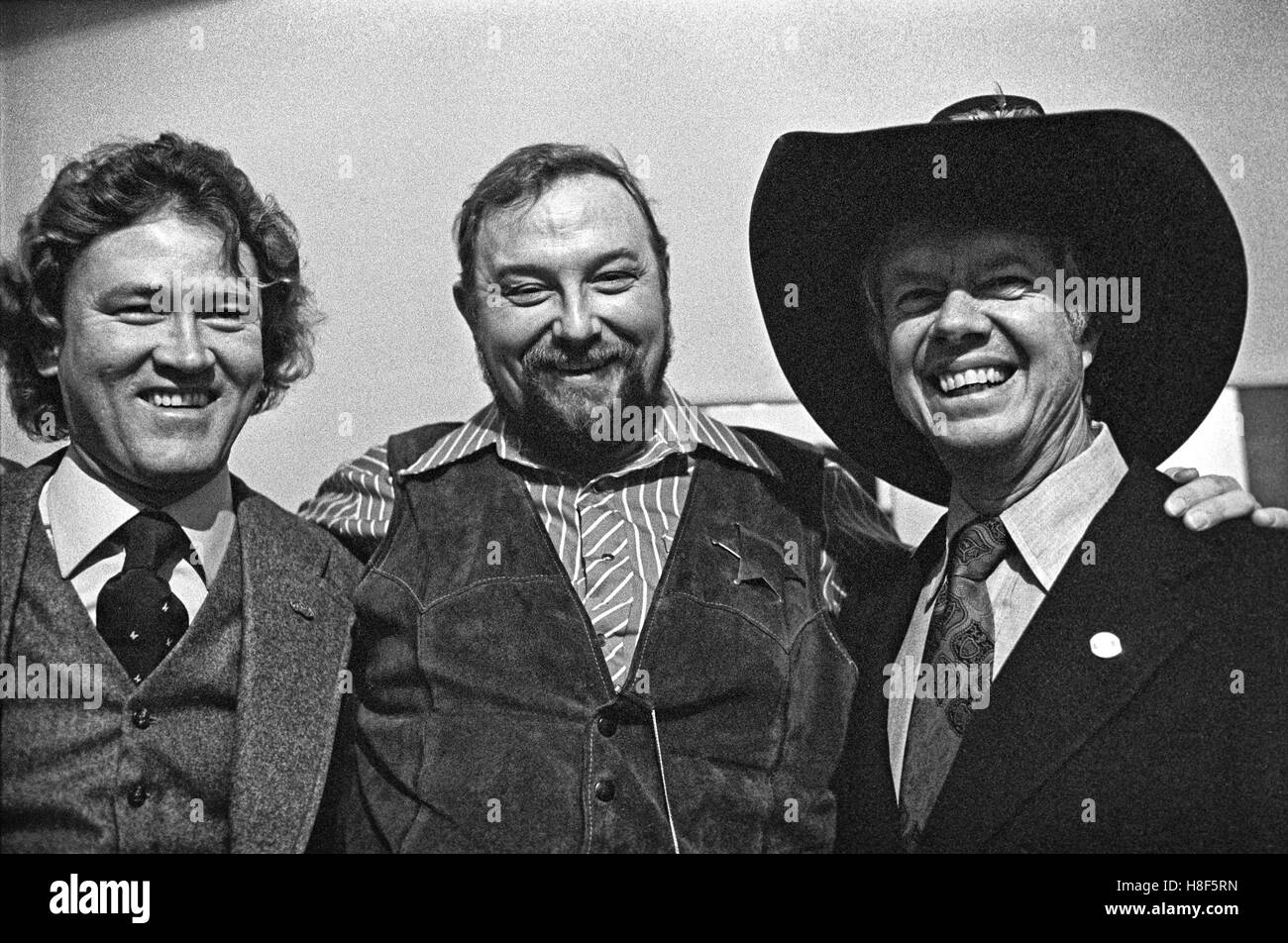 Musician Charlie Daniels (center) shares his signature cowboy hat with Democratic presidential candidate Jimmy Carter backstage at Atlanta's Fox Theater at a Carter fundraiser. Capricorn Records founder Phil Walden is at left. Stock Photo