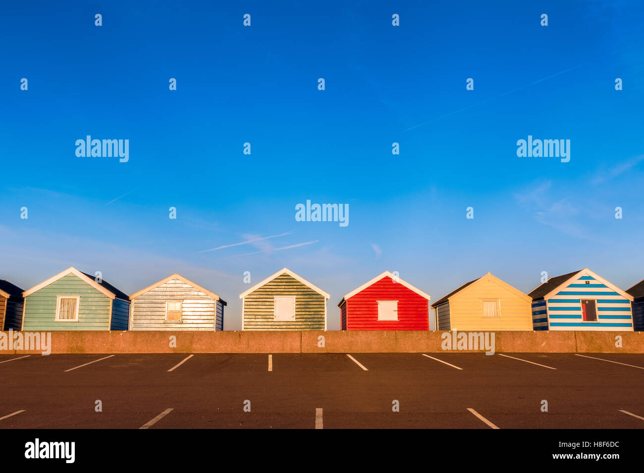 Row of colourful beach huts at sunset in Southwold, Suffolk, UK Stock Photo