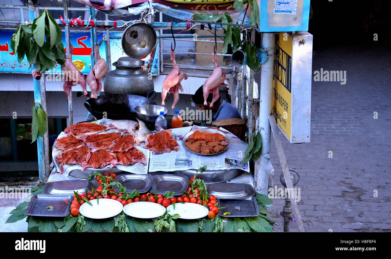 Marinated spicy meat and fish Pakistani food on display at street side restaurant Mall Road Murree Pakistan Stock Photo