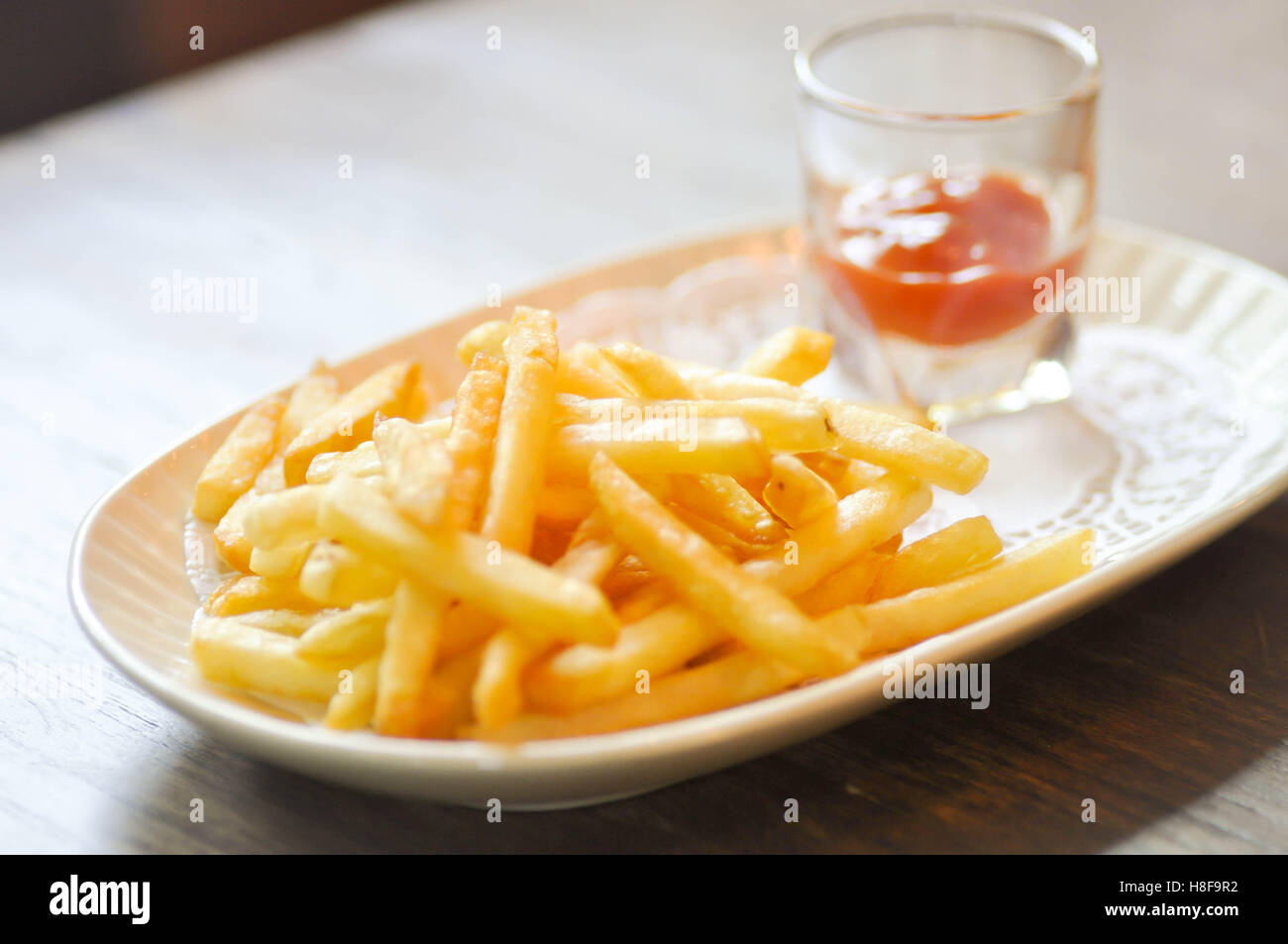French fries dish and ketchup dip in soft focus Stock Photo Alamy