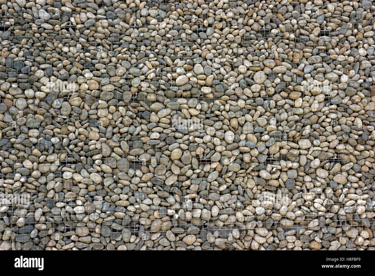 Backgrounds collection - The decorative stone wall built of sea pebbles Stock Photo