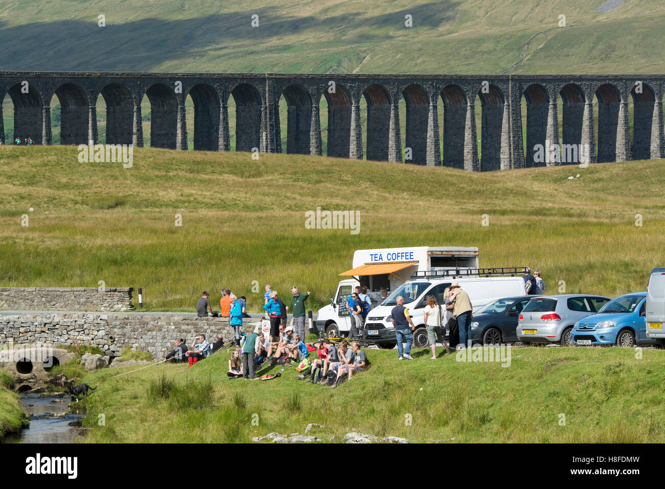 Ribblehead Viaduct on the Settle to Carlisle Railway, with lots of tourists around. Yorkshire Dales National Park, UK. Stock Photo