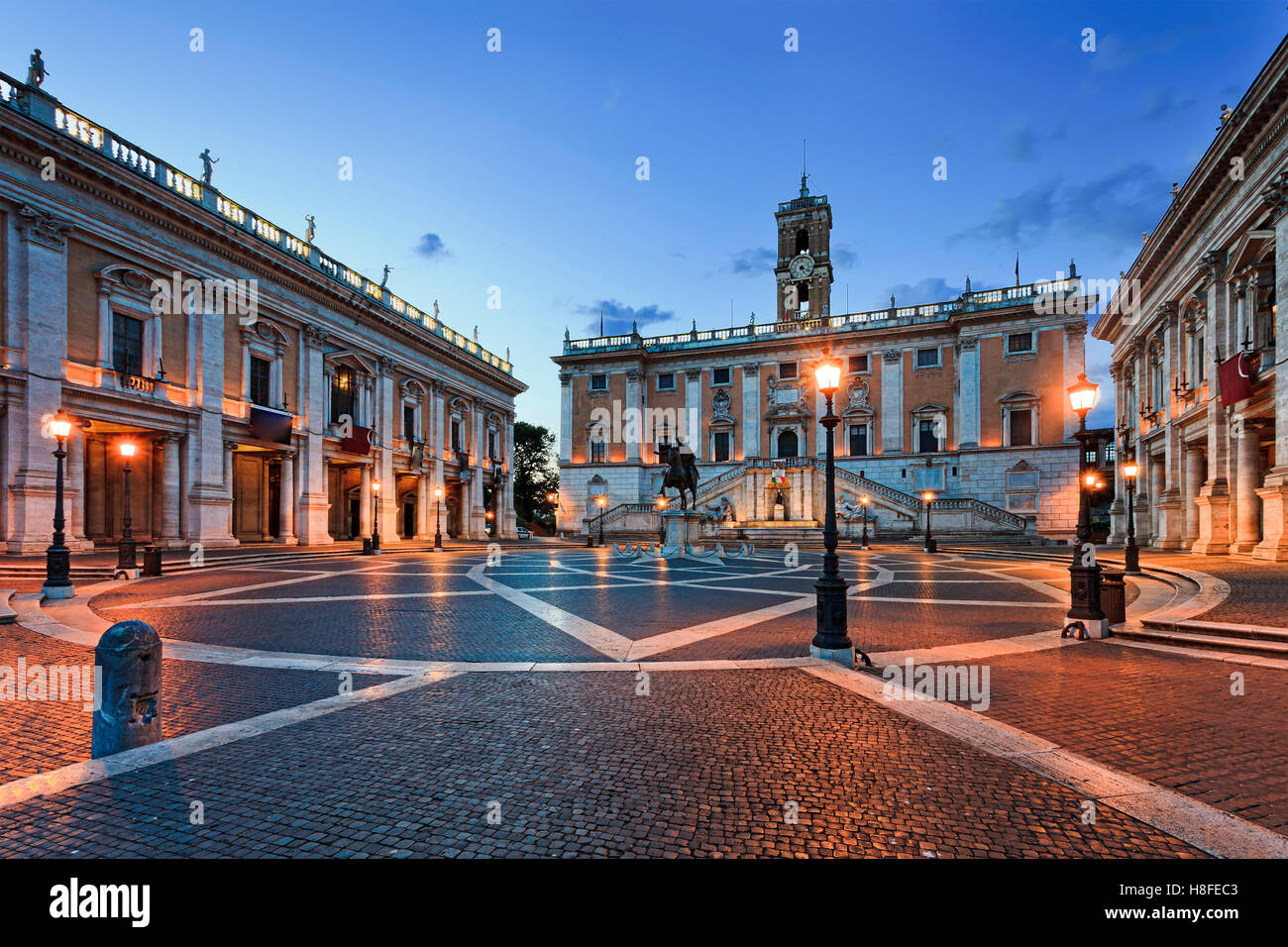 Cobblestone covered square on top of Capitoline hill in Rome, Italy, at sunrise. Historic landmark of ancient roman empire Stock Photo