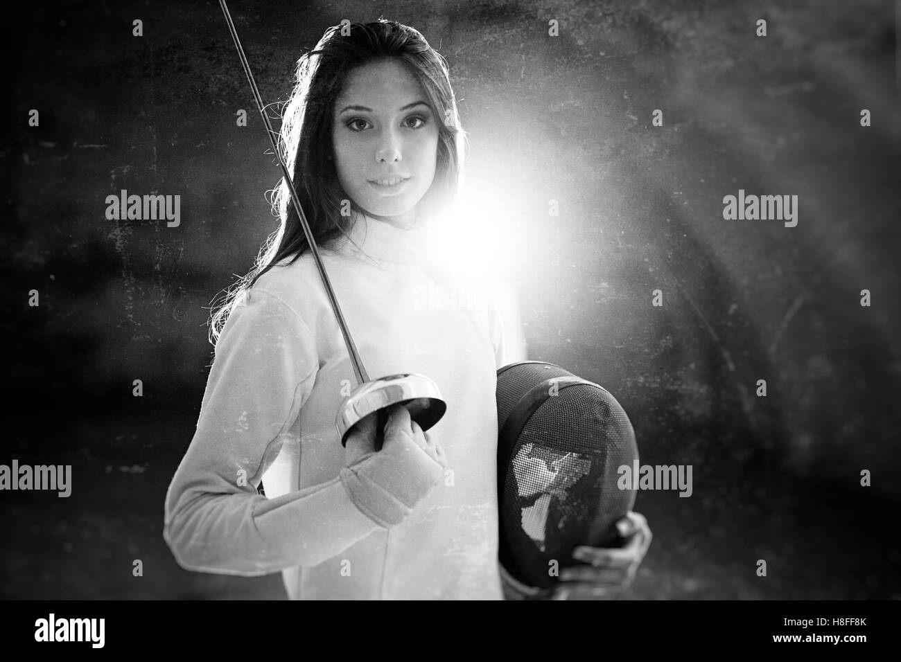 Indoor portrait of a young fencing professional. Stock Photo
