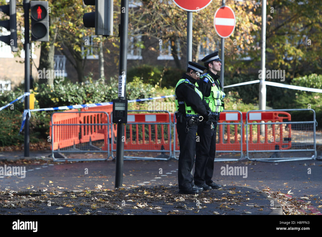 Police officers at the site of the Croydon tram crash stand during a two minute silence to mark Armistice Day. Stock Photo