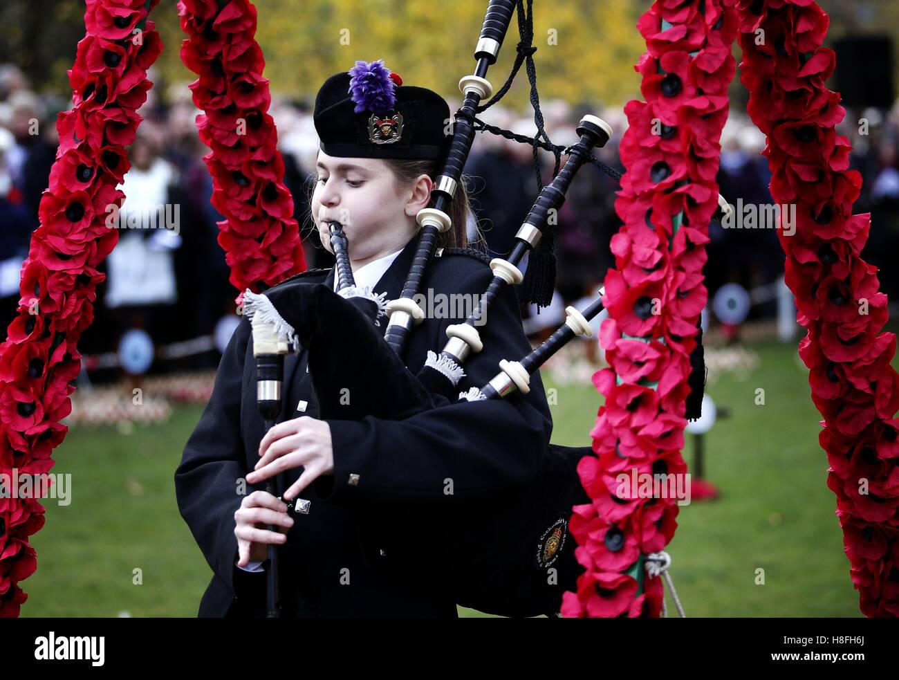 A piper plays as two minutes' silence is observed in Princes Street Gardens, Edinburgh, to mark Armistice Day, the anniversary of the end of the First World War. Stock Photo