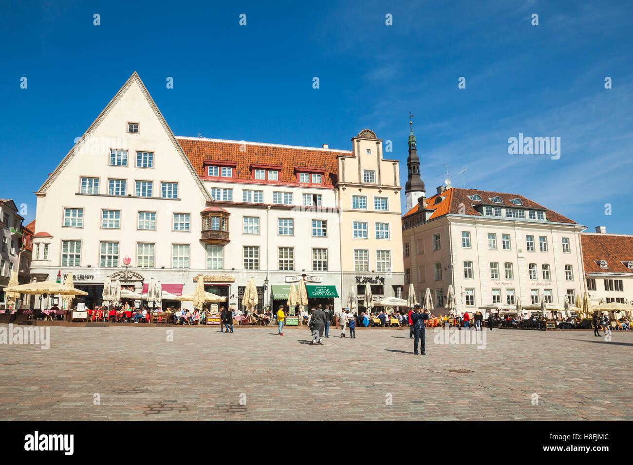 Tallinn, Estonia - May 2, 2016: Tourists and ordinary citizens are on Town Hall square in old Tallinn, bright spring sunny day Stock Photo