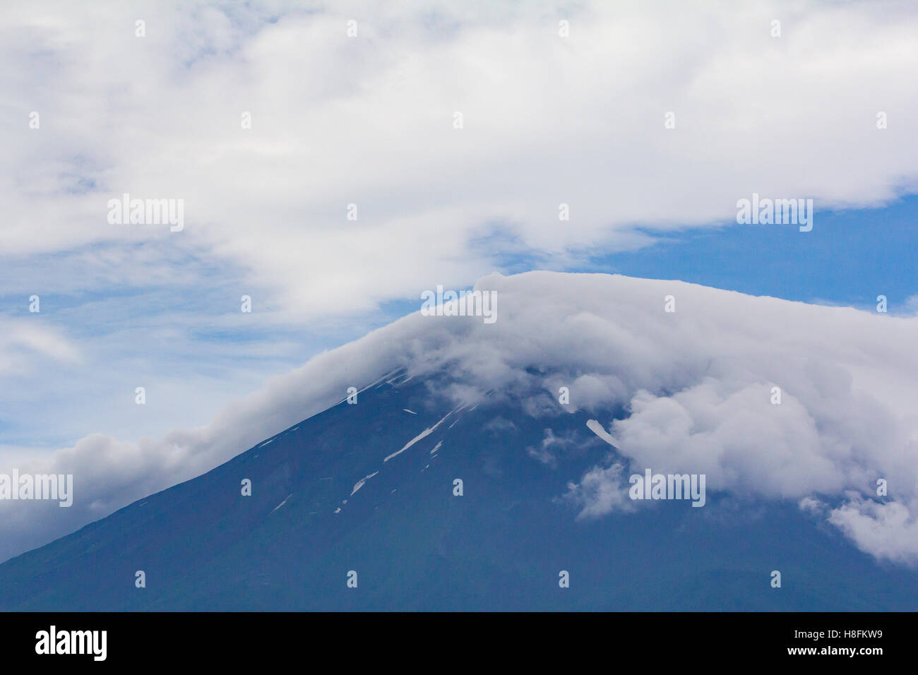 Kawaguchiko, Japan. View of the peak of Mt Fuji with clouds rolling across it. Stock Photo