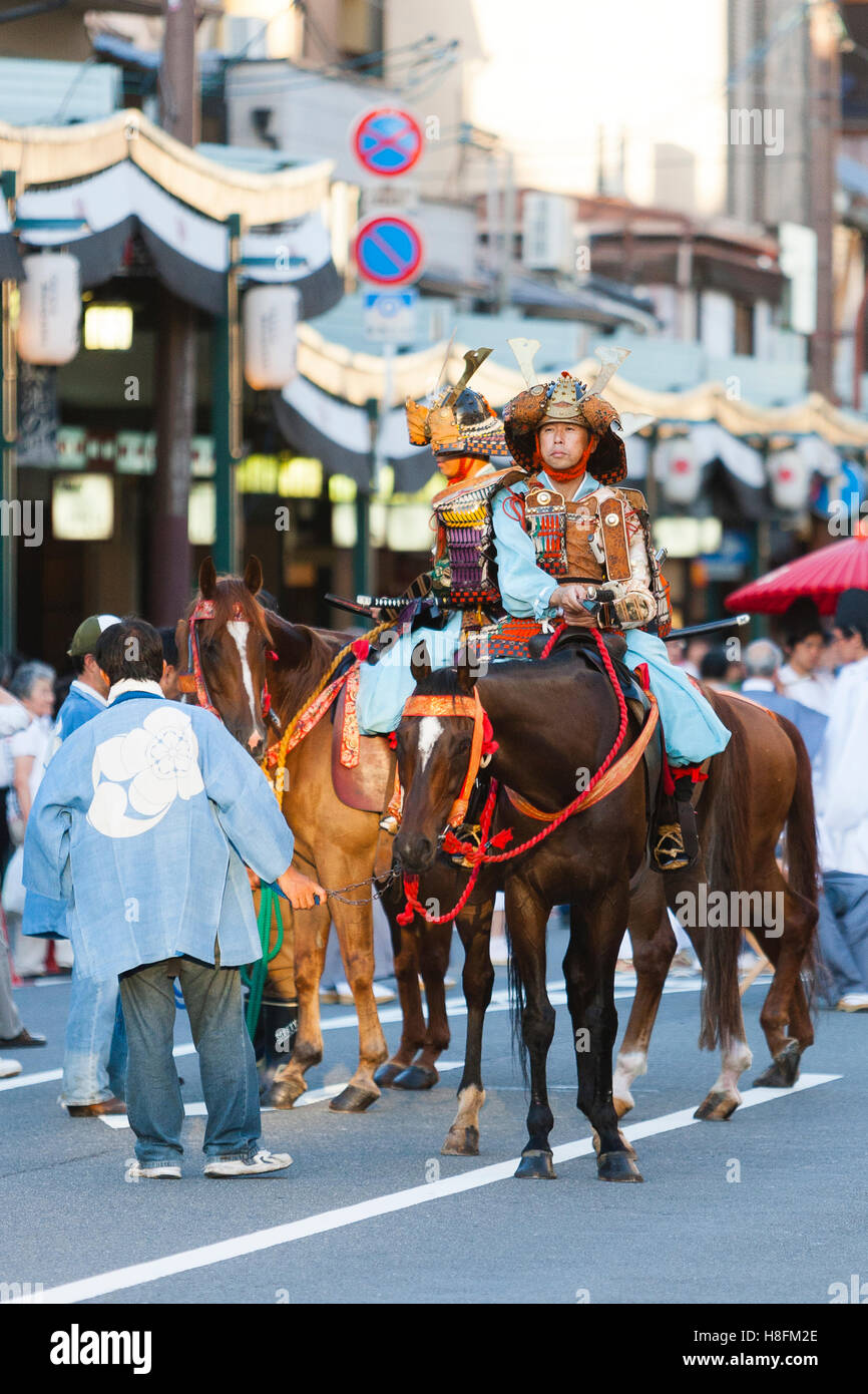 Kyoto, Japan. Men in traditional dress on horseback during Gion Matsuri festival. Stock Photo