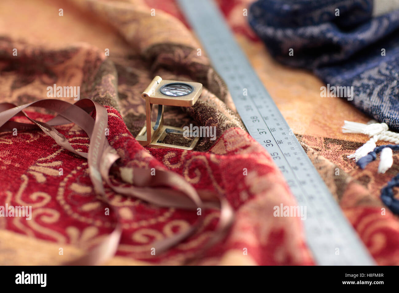 Thread counter, loupe eye glass on textiles fabric. Quality control ...