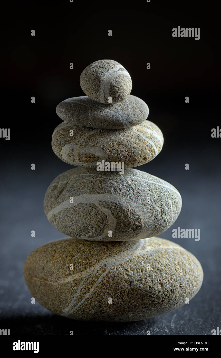 Stone Pebble Stack stack of pebble stones on black background Stock Photo - Alamy