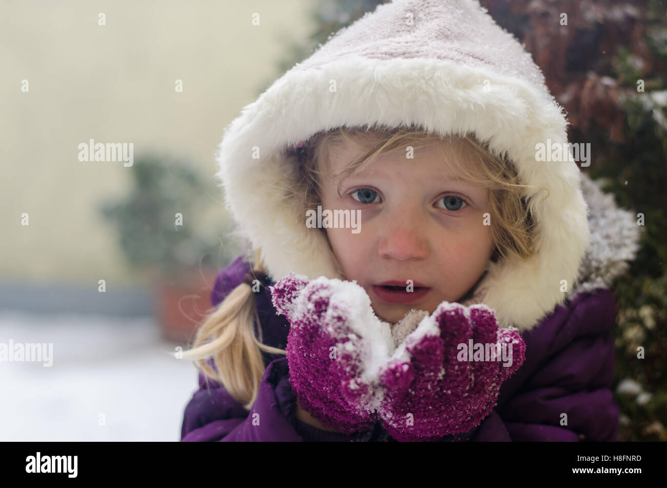 lovely little kid playing with snow Stock Photo - Alamy