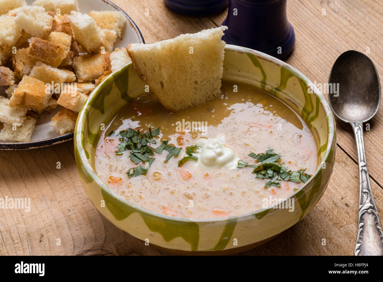 red lentil soup in bowl on rustic table setting Stock Photo