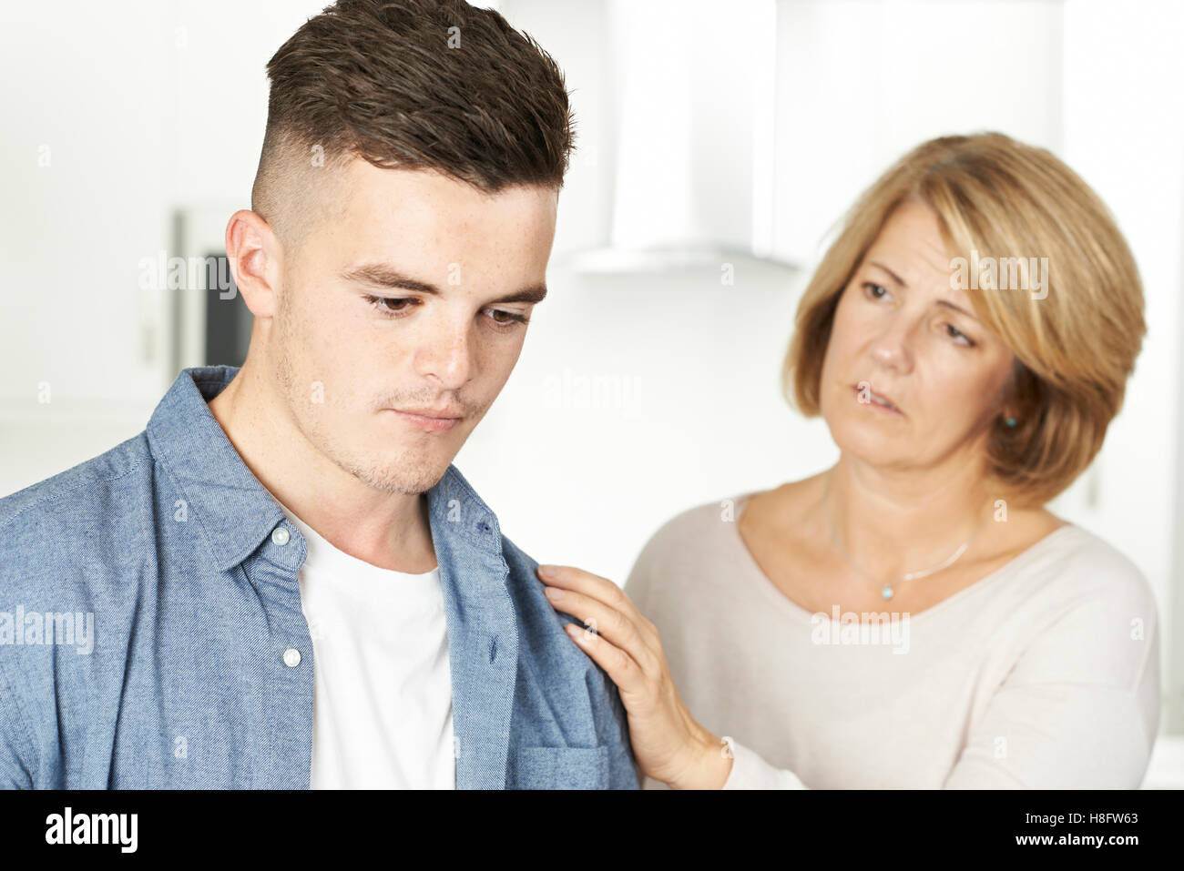 Mother Worried About Unhappy Teenage Son Stock Photo
