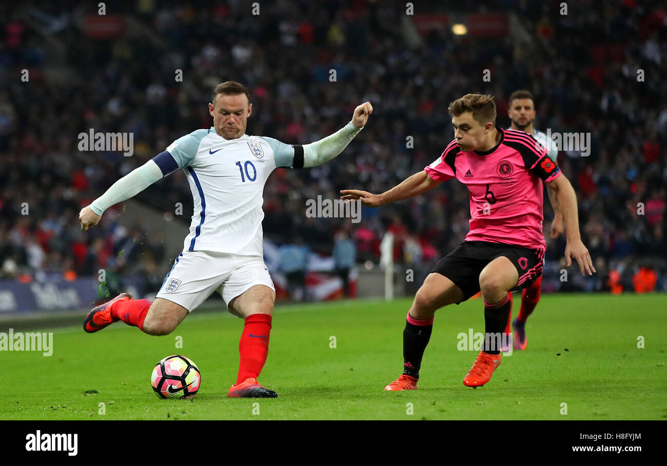 England's Wayne Rooney (left) and Scotland's James Forrest battle for the ball during the 2018 FIFA World Cup qualifying, Group F match at Wembley Stadium, London. Stock Photo