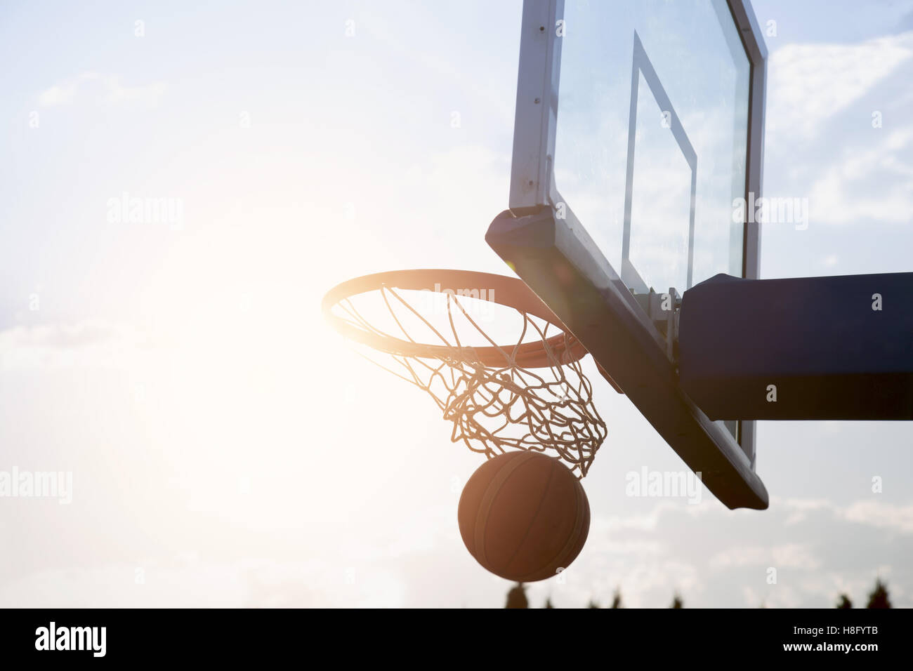 Basketball going through the basket Stock Photo - Alamy